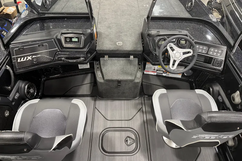 Slide: The Image of 2025 Skeeter WX2200 boat interior with dual seats, steering wheel, and control panels. - 4