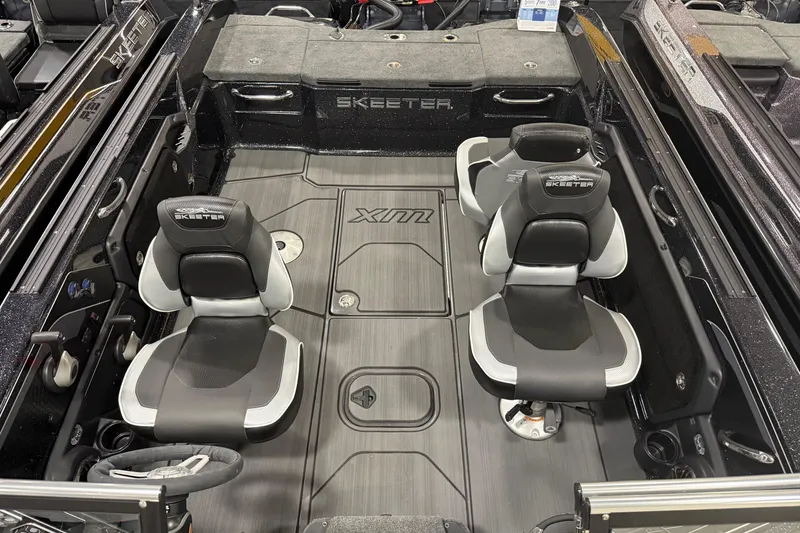 Slide: The Image of 2025 Skeeter WX2200 boat interior with four black and white seats and sleek flooring. - 6