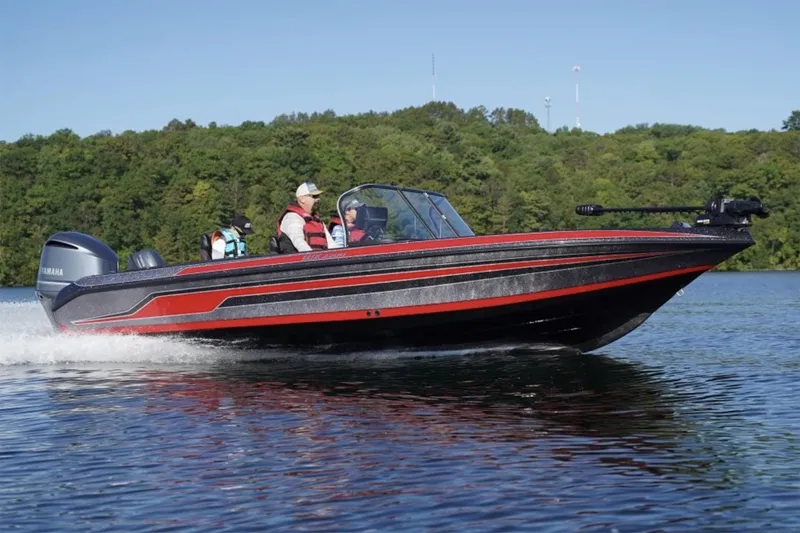 Slide: The Image of Manufacturer Provided Image: 2025 Skeeter WX2200 boat cruising on a lake with passengers, surrounded by lush greenery. - 8
