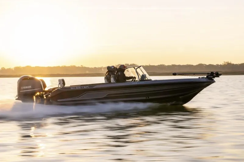 Slide: The Image of Manufacturer Provided Image: 2025 Skeeter WX2200 boat cruising on a lake at sunset. - 9