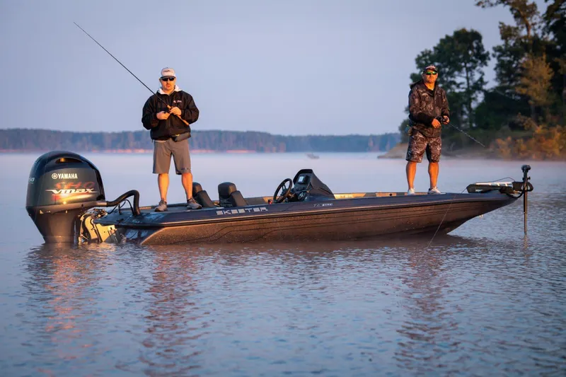 Slide: The Image of Manufacturer Provided Image: Two people fishing on a 2024 Skeeter ZX150 boat in a serene lake. - 10