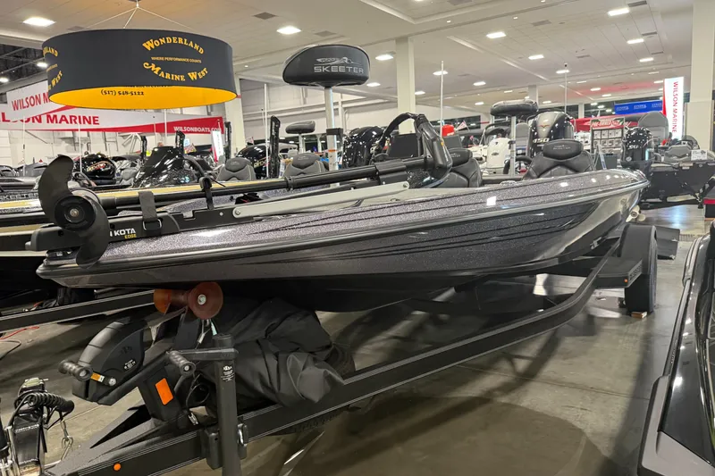 Slide: The Image of 2024 Skeeter ZX150 boat displayed at a marine exhibition indoors. - 2