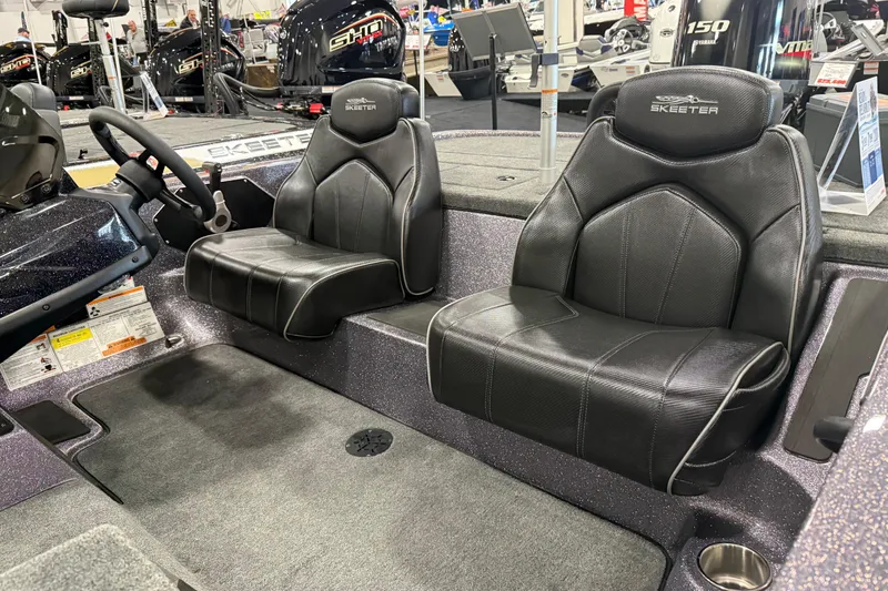 Slide: The Image of 2024 Skeeter ZX150 boat interior with black leather seats and steering wheel. - 3