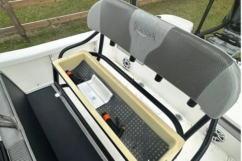 Slide: The Image of 2022 BlackJack 256 Bay boat seat with storage compartment and accessories. - 10