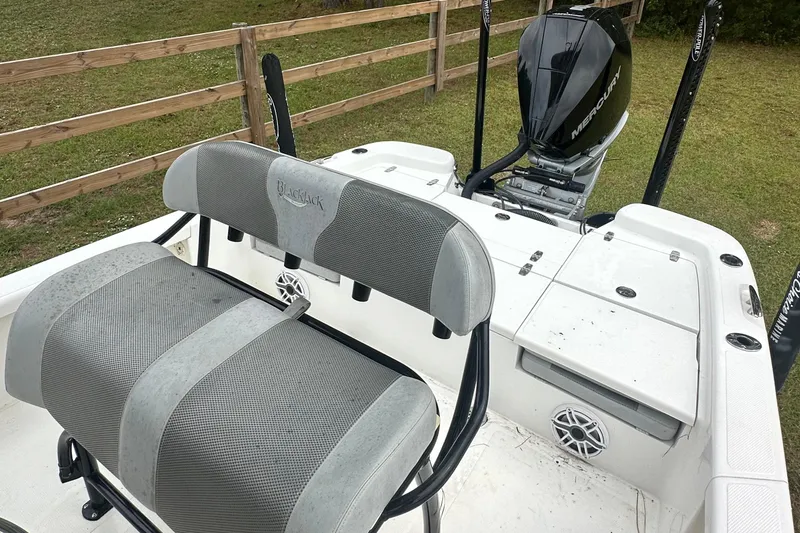 Slide: The Image of 2022 BlackJack 256 Bay boat with Mercury engine, featuring comfortable seating and spacious deck. - 11