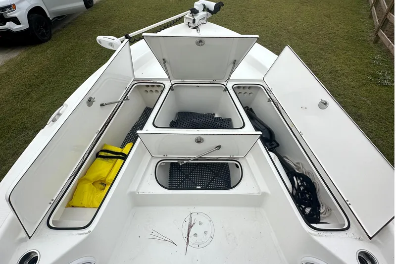 Slide: The Image of 2022 BlackJack 256 Bay boat with open storage compartments on deck. - 19