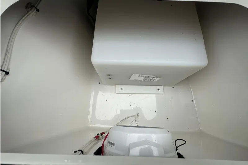 Slide: The Image of Storage compartment of 2022 BlackJack 256 Bay boat, featuring wiring and equipment. - 5