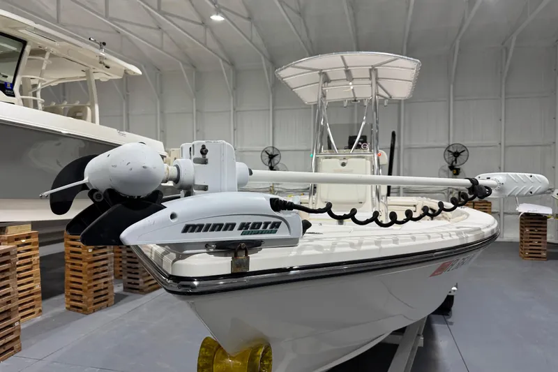 Slide: The Image of 2013 Pathfinder 2400 V boat with Minn Kota trolling motor in a storage facility. - 10