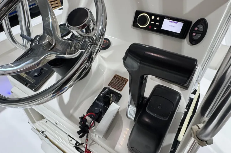 Slide: The Image of 2013 Pathfinder 2400 V boat console with steering wheel and control panel. - 14