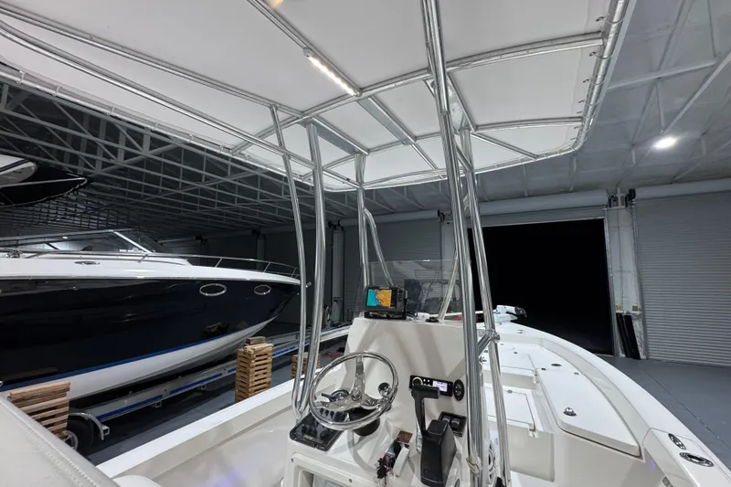 Slide: The Image of 2013 Pathfinder 2400 V boat in a garage, featuring a sleek design and modern controls. - 15