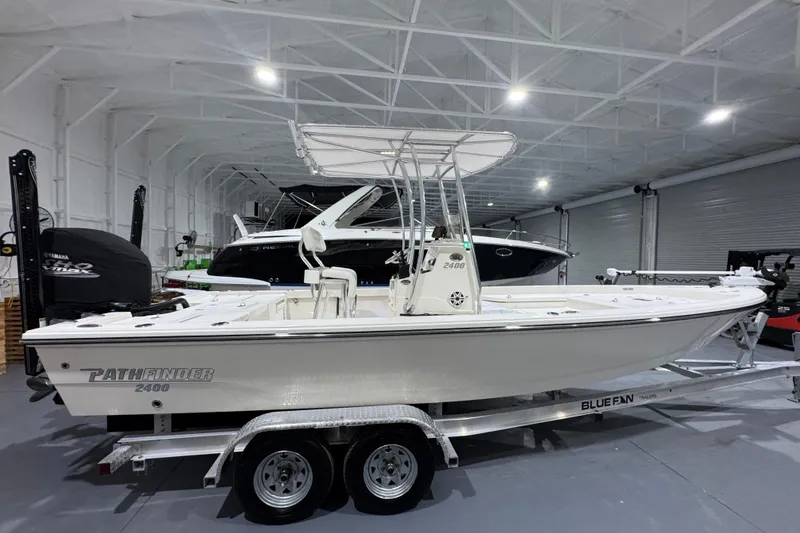 Slide: The Image of 2013 Pathfinder 2400 V boat on trailer in indoor storage facility. - 2