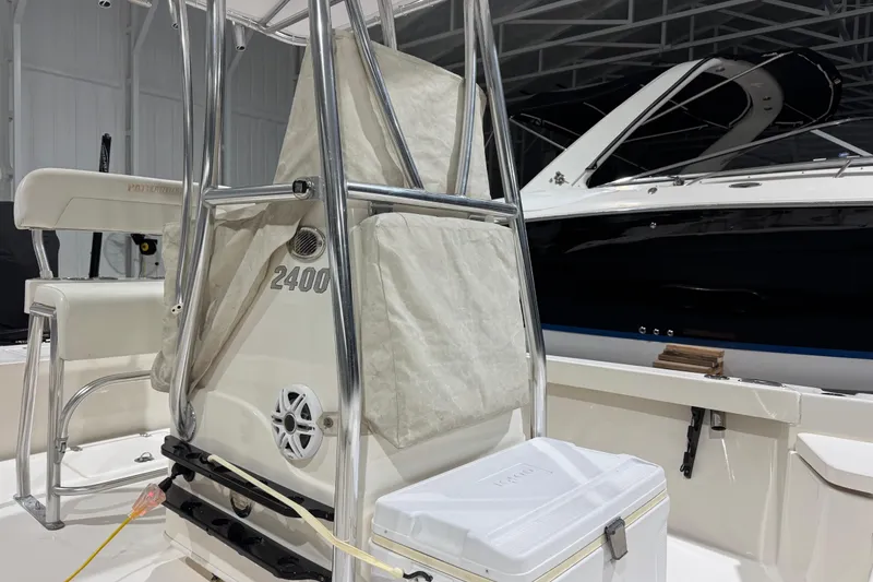 Slide: The Image of 2013 Pathfinder 2400 V boat interior with seating and storage in a garage. - 20
