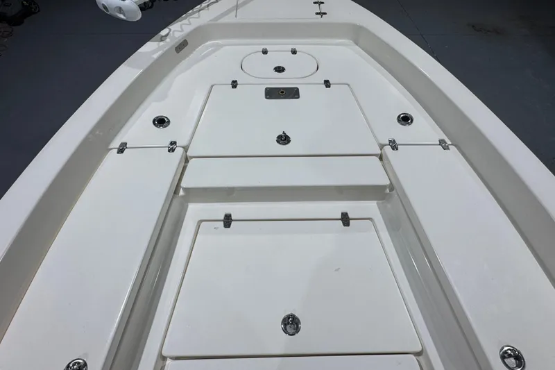 Slide: The Image of 2013 Pathfinder 2400 V boat deck with storage compartments and clean white finish. - 23