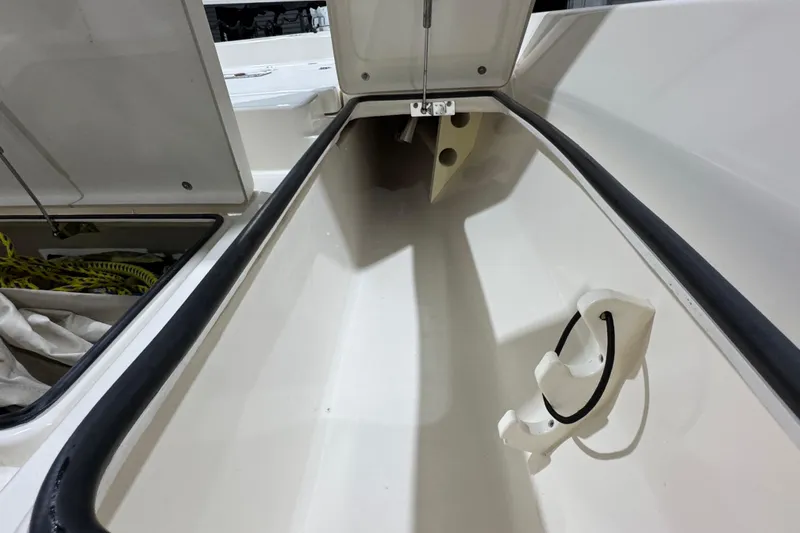 Slide: The Image of Open storage compartment in 2013 Pathfinder 2400 V boat, showing interior details. - 25