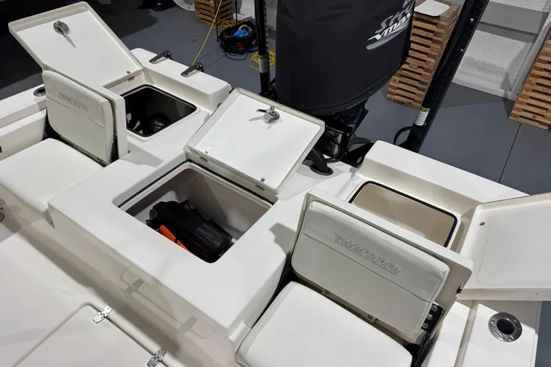 Slide: The Image of 2013 Pathfinder 2400 V boat storage compartments open, showcasing interior space. - 30