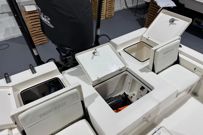 Slide: The Image of 2013 Pathfinder 2400 V boat interior with open storage compartments. - 31