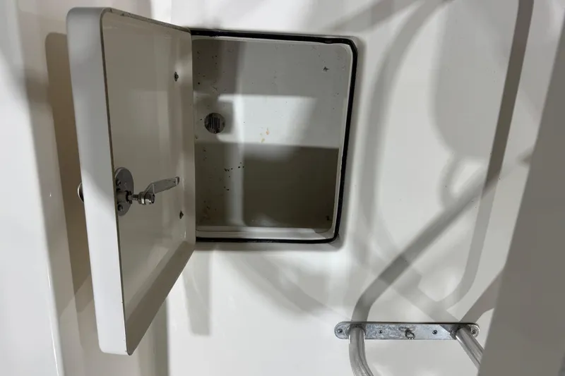 Slide: The Image of Open storage compartment on 2013 Pathfinder 2400 V boat, showing interior details. - 33