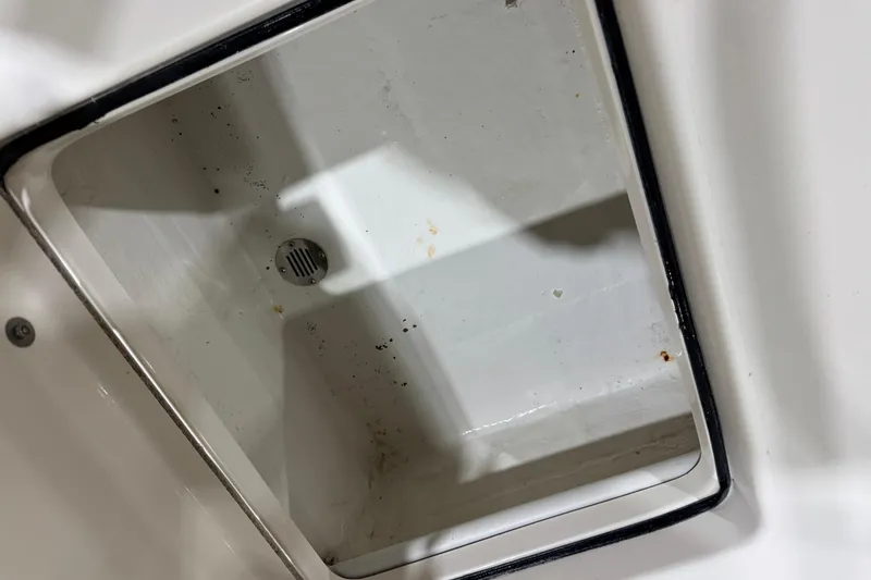 Slide: The Image of Open storage compartment in 2013 Pathfinder 2400 V boat, showing interior details. - 34