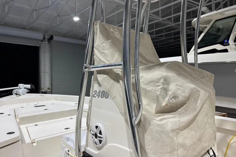 Slide: The Image of 2013 Pathfinder 2400 V boat with covered seating in a garage setting. - 35