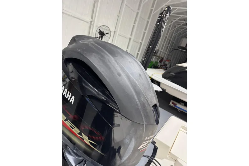 Slide: The Image of 2013 Pathfinder 2400 V with Yamaha outboard engine in a boat storage facility. - 36