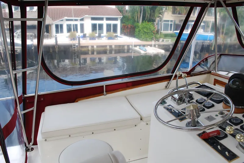 Slide: The Image of Interior view of 1987 Jersey Dawn boat cockpit with waterfront background. - 10