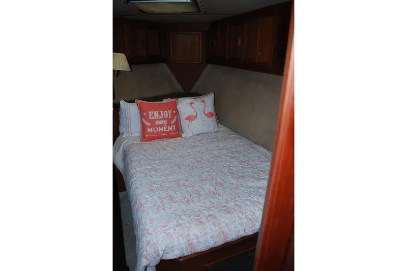 Slide: The Image of Cozy bedroom in 1987 Jersey Dawn boat with decorative pillows and wooden cabinets. - 19