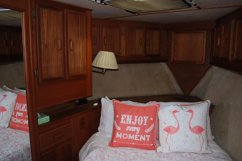 Slide: The Image of Cozy cabin interior of 1987 Jersey Dawn boat with decorative pillows and wooden cabinets. - 20