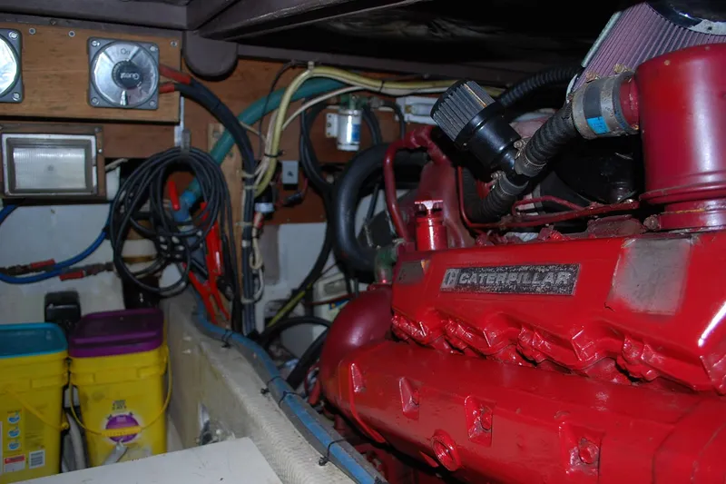Slide: The Image of Engine room of 1987 Jersey Dawn boat with red Caterpillar engine and wiring. - 23