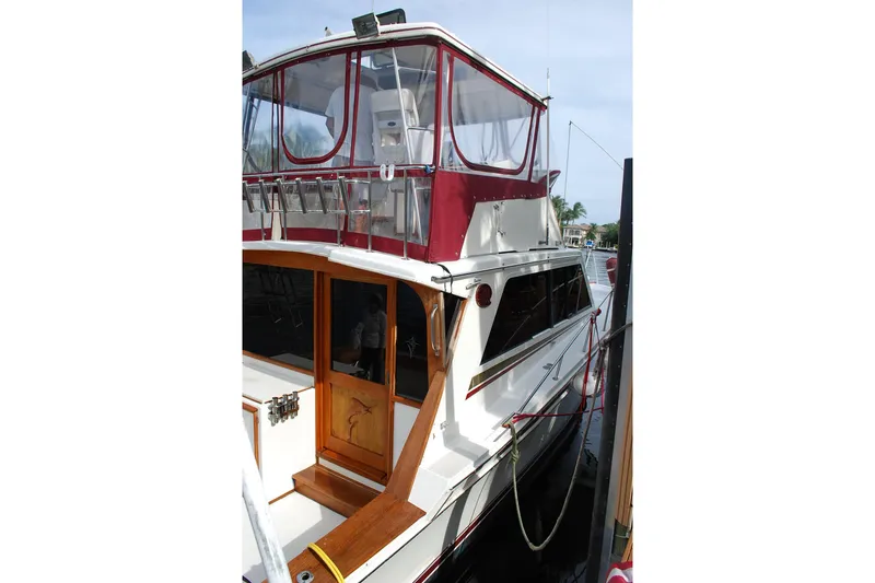 Slide: The Image of 1987 Jersey Dawn boat with red canopy docked at marina. - 3