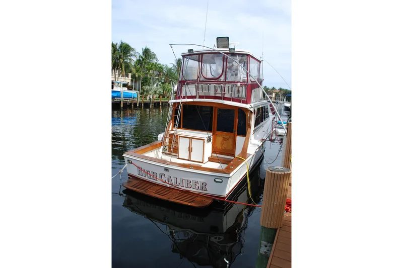 Slide: The Image of 1987 Jersey Dawn boat docked, featuring wooden accents and enclosed upper deck. - 5