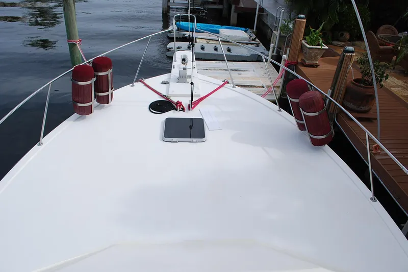 Slide: The Image of 1987 Jersey Dawn boat docked, featuring a clean white deck and red fenders. - 7