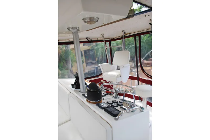Slide: The Image of 1987 Jersey Dawn boat helm with white seating and control panel. - 9