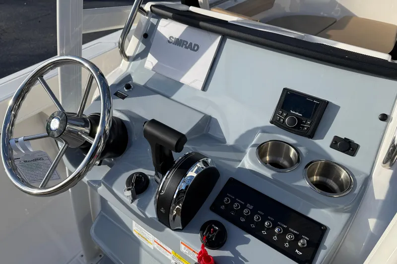 Slide: The Image of 2026 Bayliner Trophy T22CC helm with steering wheel, controls, and cup holders. - 10