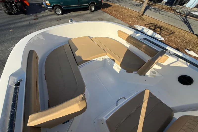 Slide: The Image of 2026 Bayliner Trophy T22CC boat interior with tan seating and spacious layout. - 11