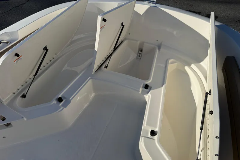 Slide: The Image of 2026 Bayliner Trophy T22CC boat storage compartments open, showcasing spacious interior design. - 13