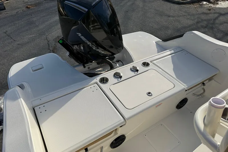 Slide: The Image of 2026 Bayliner Trophy T22CC boat with Mercury engine, featuring a spacious deck layout. - 7