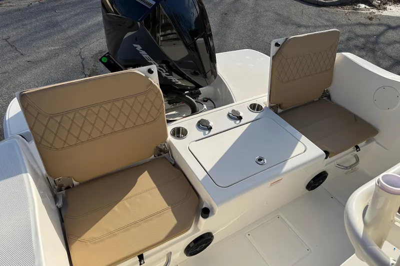Slide: The Image of 2026 Bayliner Trophy T22CC boat seating with tan cushions and storage compartment. - 8