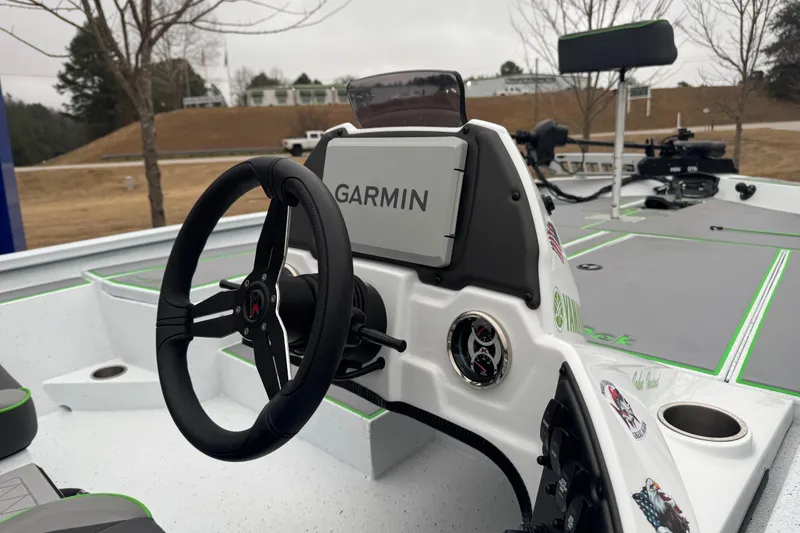 Slide: The Image of 2026 Xpress H20 Bass boat dashboard with Garmin navigation system and steering wheel. - 11