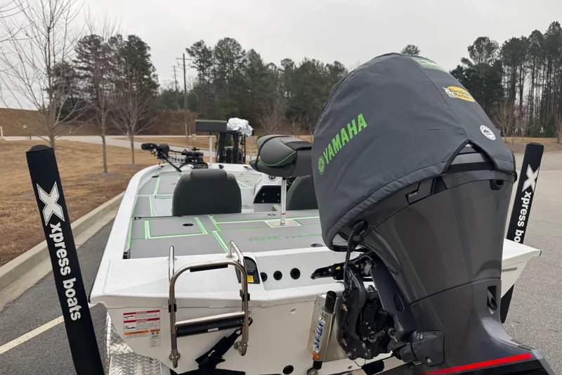 Slide: The Image of 2026 Xpress H20 Bass boat with Yamaha engine in a parking lot. - 15