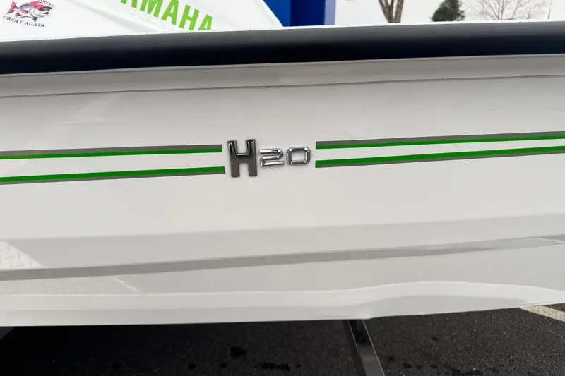 Slide: The Image of 2026 Xpress H20 Bass boat with green stripes and H20 emblem. - 3