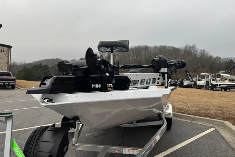 Slide: The Image of 2026 Xpress H20 Bass boat with Minn Kota motor on trailer, parked outdoors. - 5