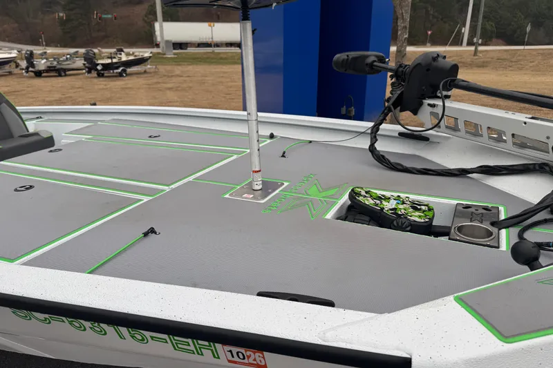 Slide: The Image of 2026 Xpress H20 Bass boat deck with green accents and fishing equipment. - 8