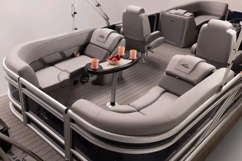 Slide: The Image of Manufacturer Provided Image: Luxurious 2026 SunCatcher Fusion 324RC pontoon boat interior with plush seating and table. - 12