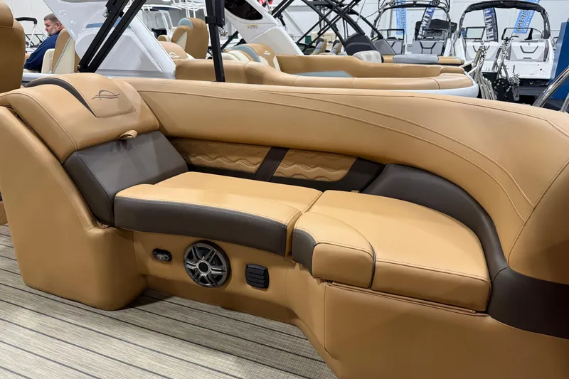 Slide: The Image of Luxurious seating on 2026 SunCatcher Fusion 324RC boat, featuring tan and brown upholstery. - 8