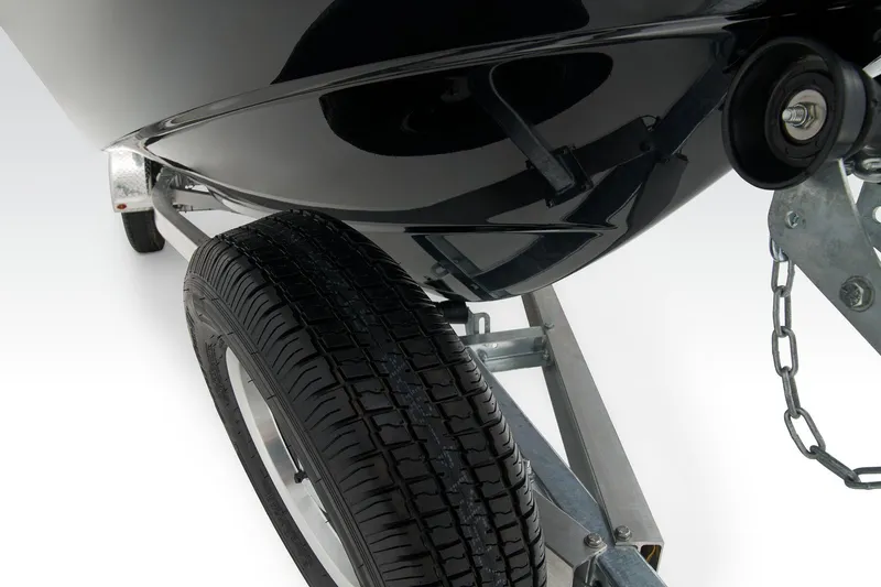 Slide: The Image of 2026 Tahoe T21 boat with Mercury Pro XS engine and swim ladder on a concrete surface. - 15