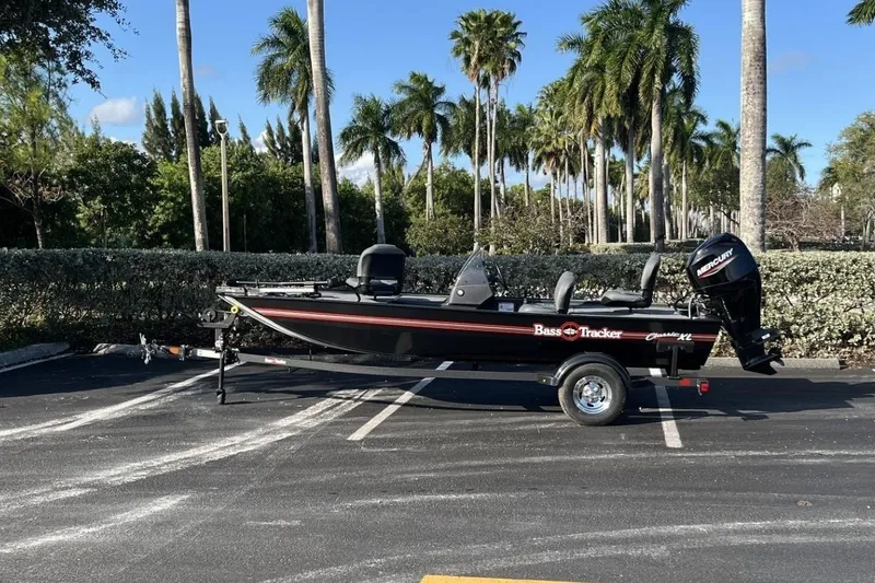 The Image of 2026 Bass Tracker Classic XL boat in a parking lot with palm trees. - 0