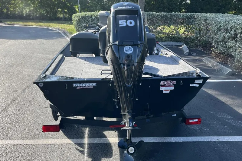 Slide: The Image of 2026 Tracker Bass Tracker Classic XL boat with Mercury 50 engine, parked outdoors. - 12
