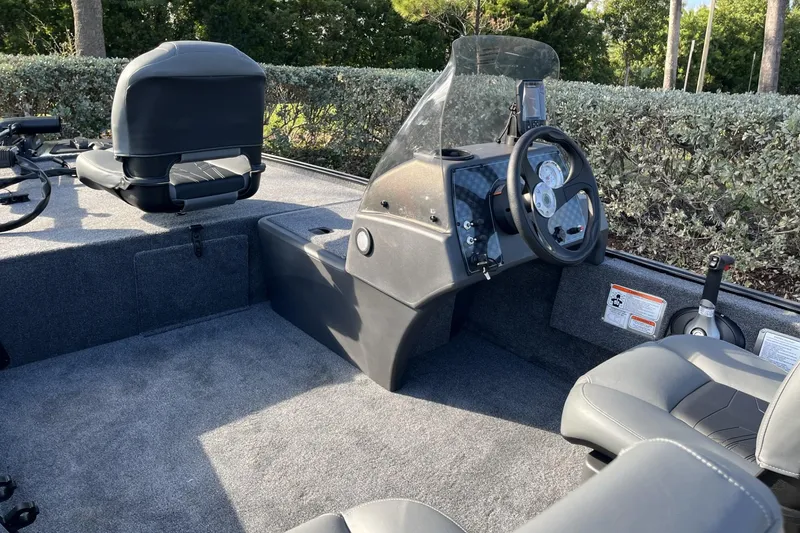 Slide: The Image of 2026 Tracker Bass Tracker Classic XL boat interior with steering console and seating. - 14