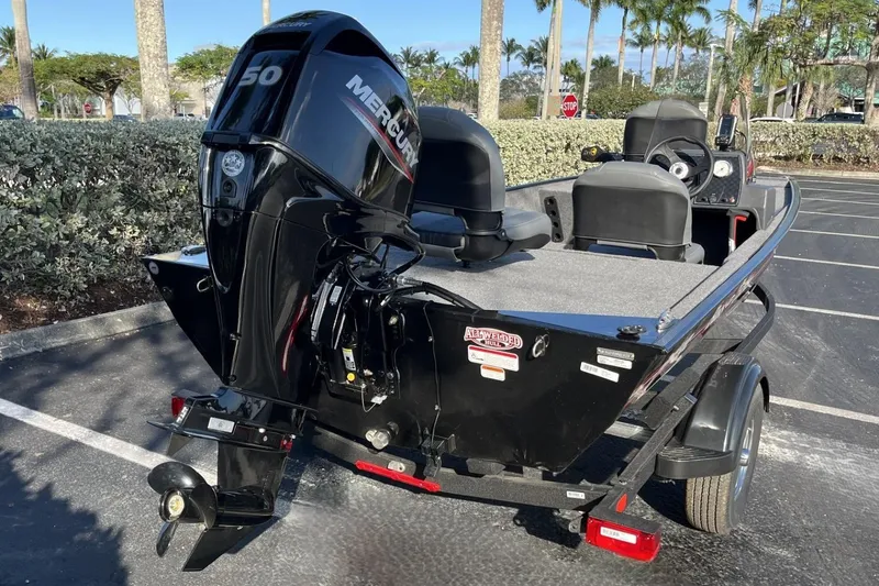Slide: The Image of 2026 Tracker Bass Tracker Classic XL boat with Mercury engine in parking lot. - 15