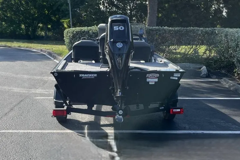 Slide: The Image of 2026 Tracker Bass Tracker Classic XL boat with 50HP engine in parking lot. - 3